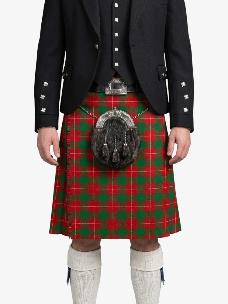 Person wearing a red and green plaid kilt with a black jacket on a white background