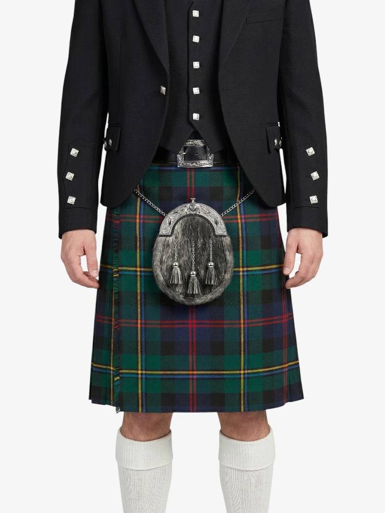 Person wearing a black jacket and tartan kilt with a sporran on a white background