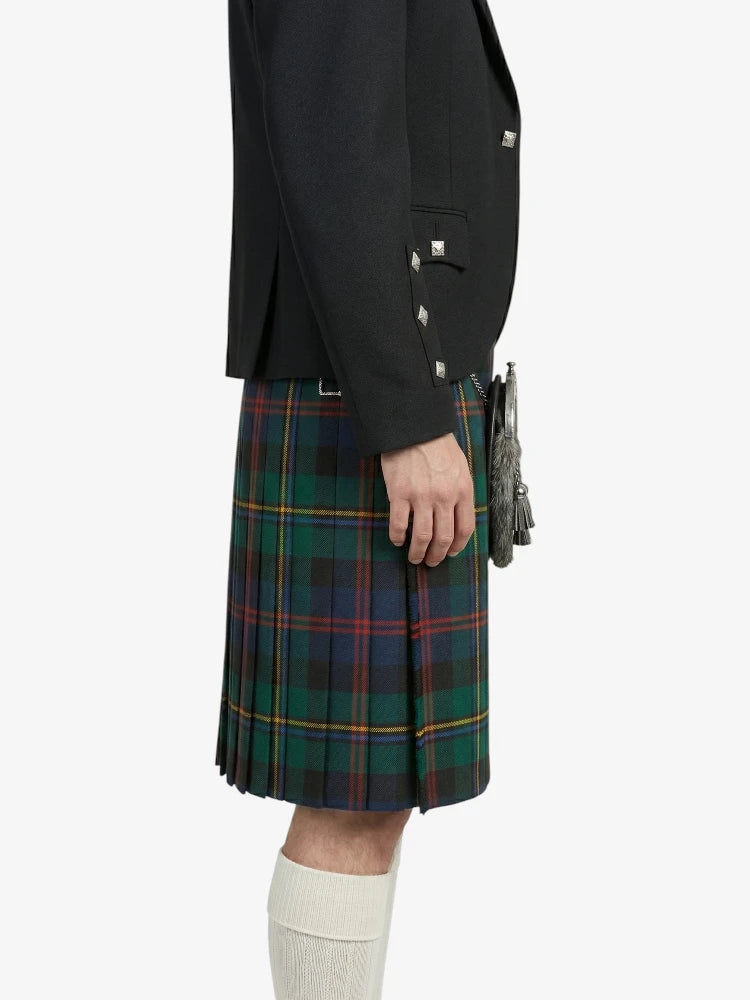 Person wearing a black jacket and green plaid kilt on a white background