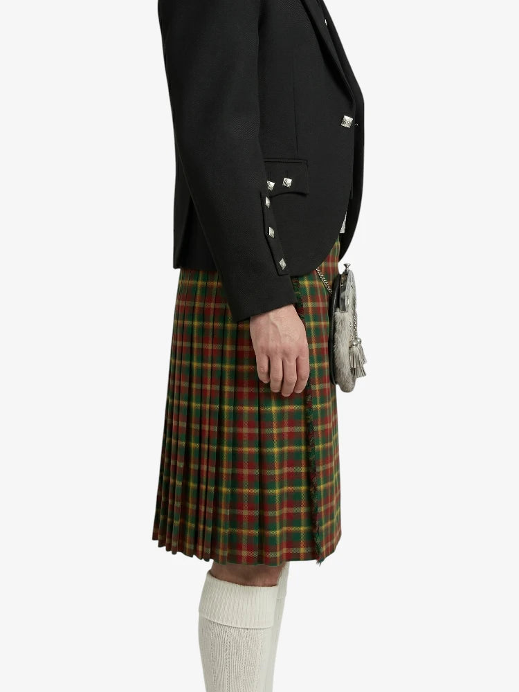 Person wearing a black blazer and plaid kilt on a white background