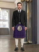 Man wearing a traditional Scottish kilt in an elegant interior setting
