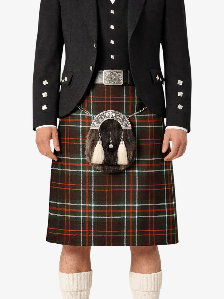 Person wearing a traditional Scottish kilt with a tartan pattern on a white background