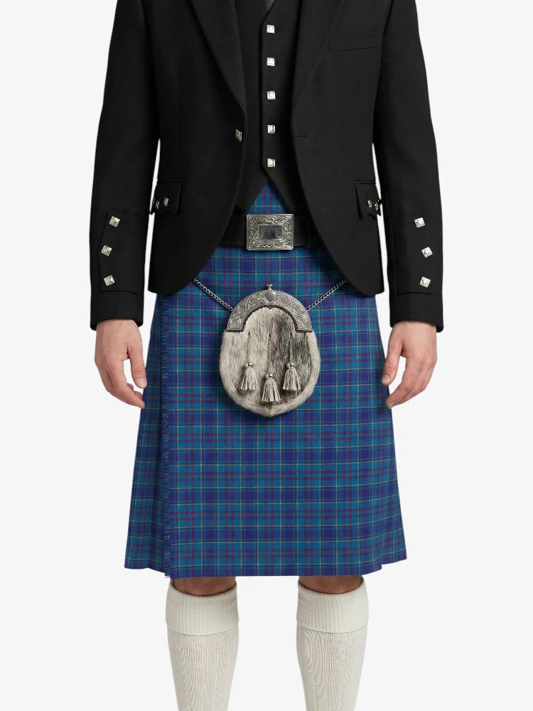 Person wearing a blue plaid kilt with a black jacket on a white background