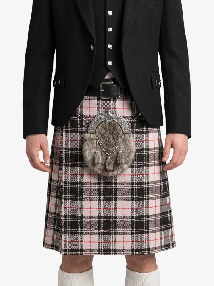 Person wearing a black jacket, plaid kilt, and sporran on a white background
