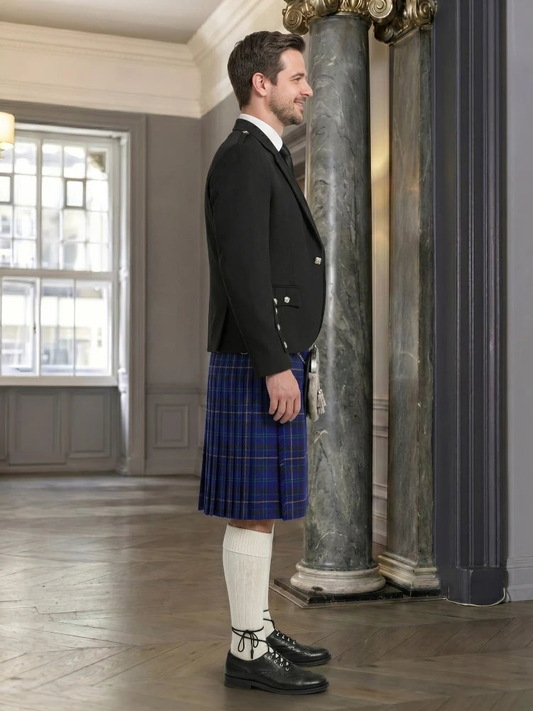 Man wearing a traditional kilt in an elegant interior setting