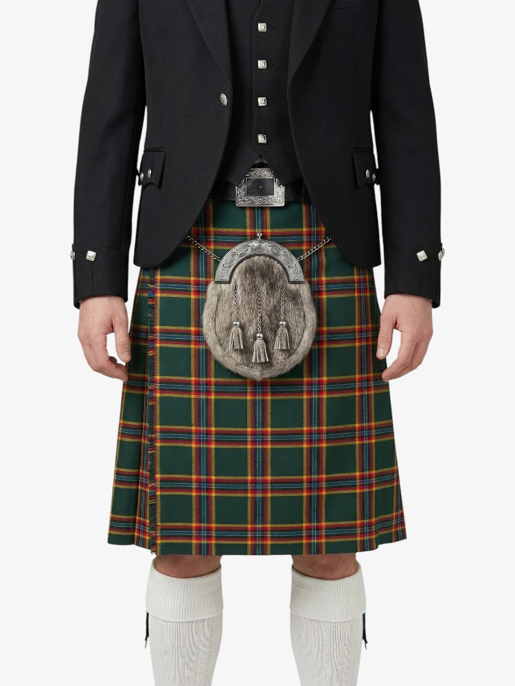 Person wearing a traditional Scottish kilt with a jacket on a white background