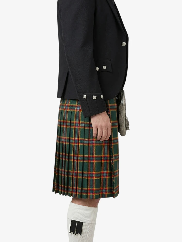Person wearing a black jacket and green plaid kilt on a white background