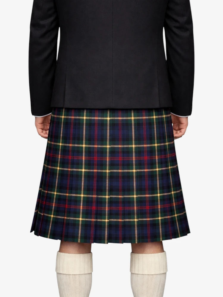 Person wearing a black blazer and plaid kilt on a white background