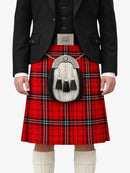 Person wearing a red tartan kilt with a sporran on a white background