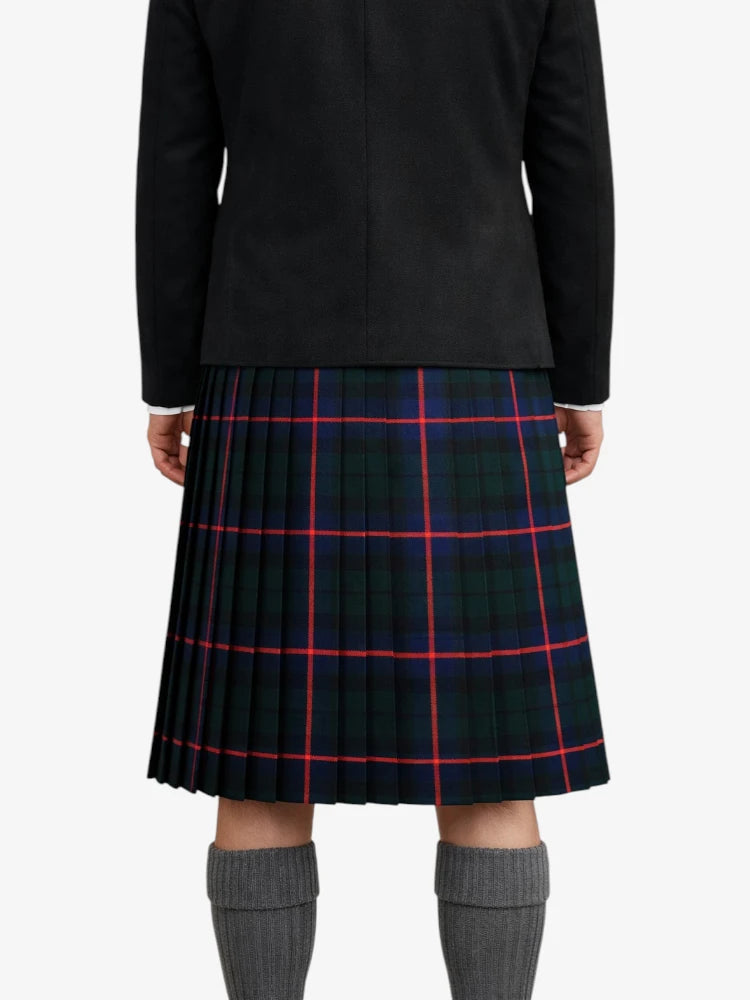 Person wearing a black jacket and plaid kilt on a white background