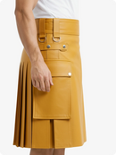 Mustard yellow kilt with belt and button details on a white background