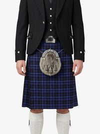 Person wearing a traditional Scottish kilt with a tartan pattern on a white background