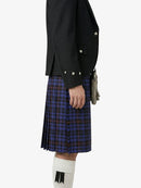 Person wearing a black jacket and blue plaid kilt on a white background
