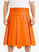 Orange pleated skirt worn by a person on a white background