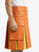Orange and yellow pleated skirt worn by a person on a white background
