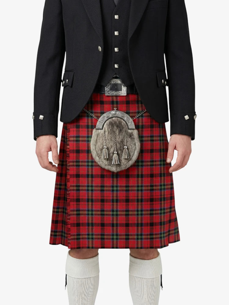 Person wearing a red tartan kilt with a black jacket on a white background