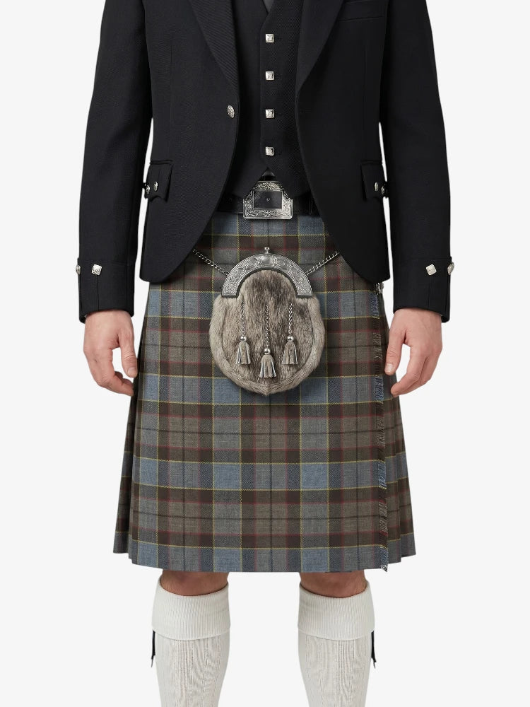Traditional Scottish kilt with a tartan pattern worn by a person on a white background