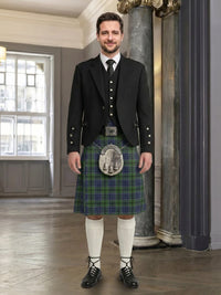 Man wearing a traditional Scottish kilt in an elegant interior setting