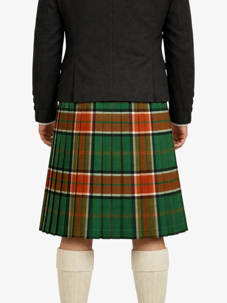 Person wearing a green plaid kilt with a black jacket on a white background