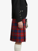 Person wearing a black jacket and red plaid kilt on a white background