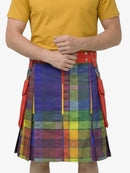 Person wearing a colorful plaid kilt with a yellow shirt on a white background