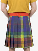 Person wearing a colorful plaid kilt with an orange waistband on a white background
