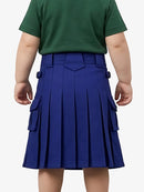 Child wearing a green shirt and blue pleated skirt on a white background