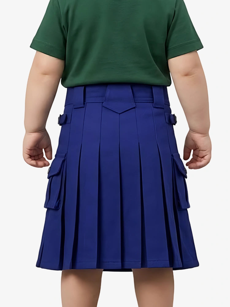 Child wearing a green shirt and blue pleated skirt on a white background