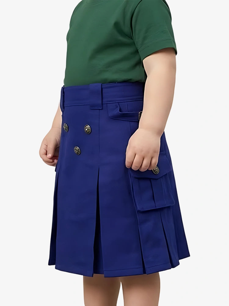 Child wearing a blue pleated skirt with a green top on a white background