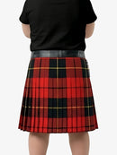 Person wearing a red and black plaid skirt with a plain background