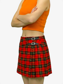 Person wearing an orange sleeveless top and red plaid skirt on a white background