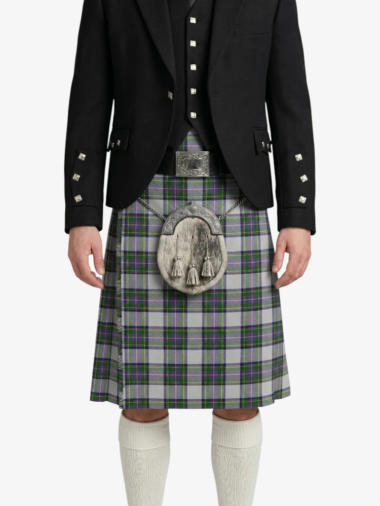 Person wearing a traditional Scottish kilt with a jacket on a white background