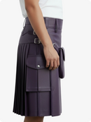 Person wearing a purple pleated kilt on a white background