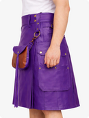Purple leather skirt with gold buttons and a brown leather bag on a white background