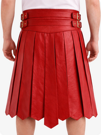 Red pleated leather skirt with gold buckles on a white background
