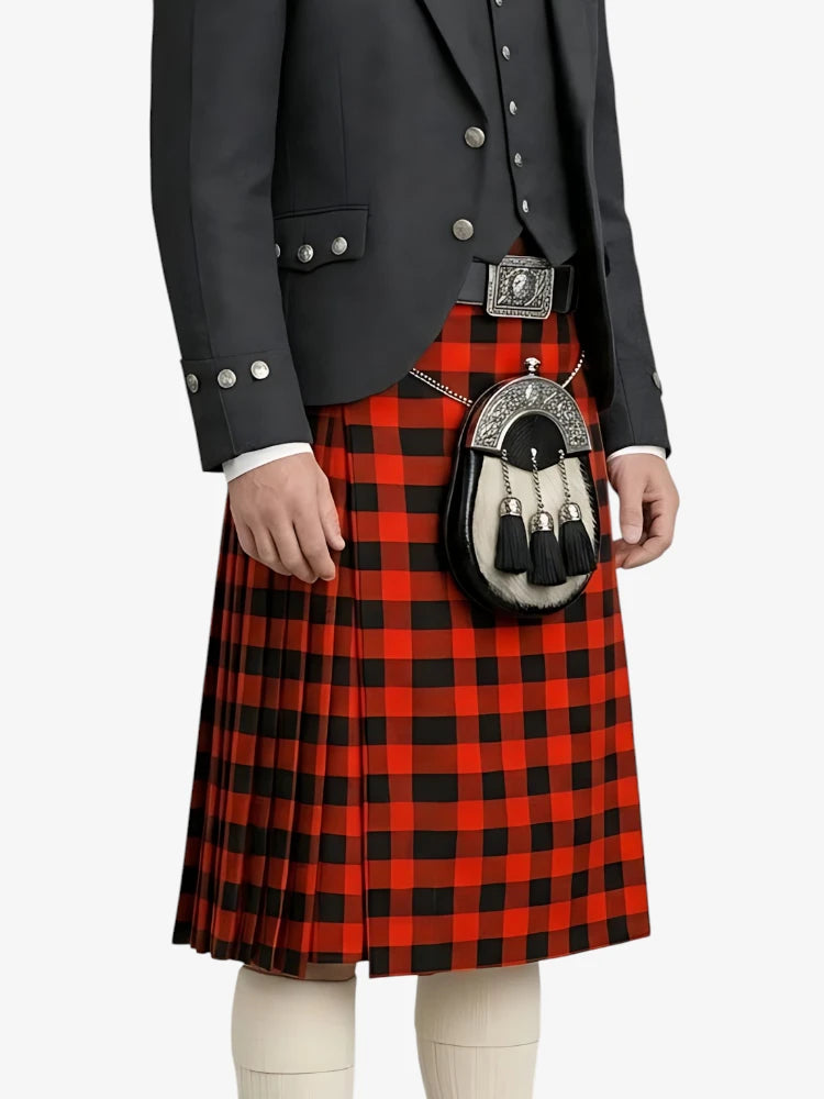 Person wearing a red and black plaid kilt with a dark jacket on a white background