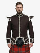 Man wearing a dark brown jacket with white trim and a royal stewart tartan plaid kilt on a white background
