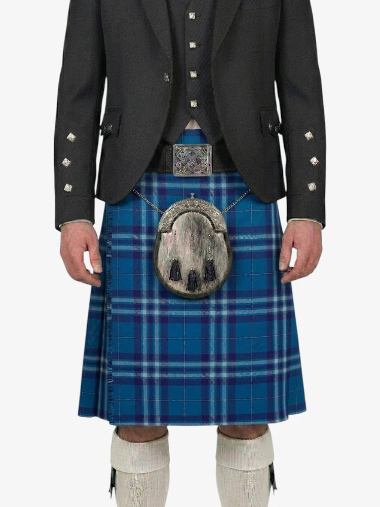 Person wearing a blue plaid kilt with a black jacket on a white background