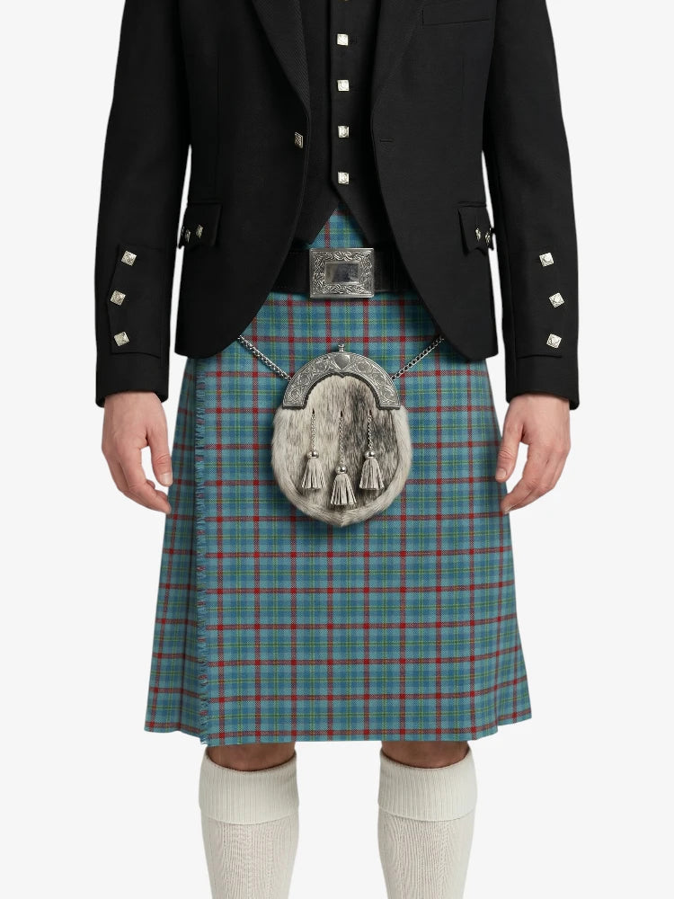 Person wearing a traditional Scottish kilt with a jacket on a white background