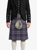 Person wearing a black jacket and blue plaid kilt with a silver sporran on a white background