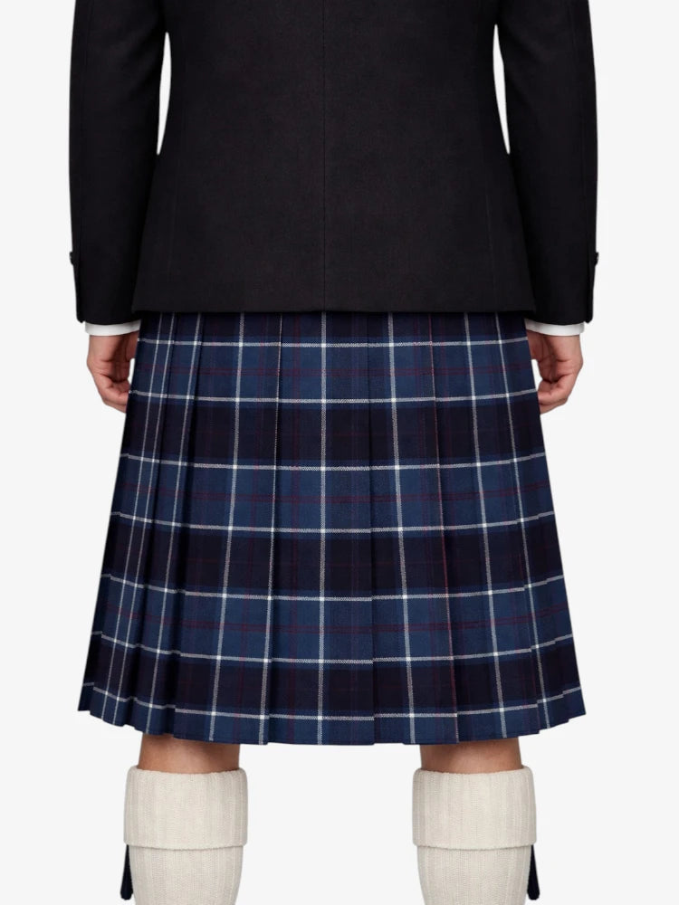 Person wearing a dark coat and blue plaid kilt with white knee-high boots on a white background