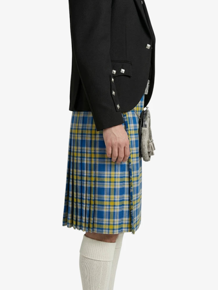 Person wearing a black blazer and blue plaid kilt on a white background