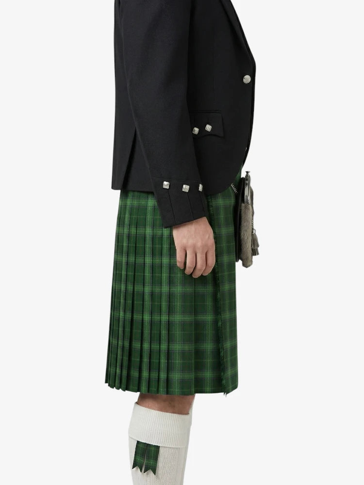 Person wearing a black jacket and green plaid kilt on a white background