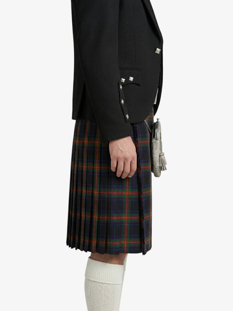 Person wearing a black jacket and plaid kilt on a white background