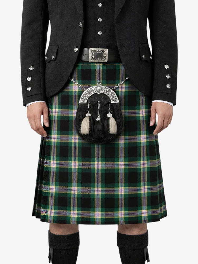Person wearing a traditional Scottish kilt with a tartan pattern on a white background