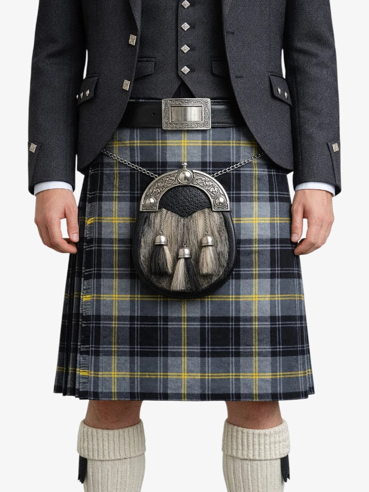 Person wearing a traditional Scottish kilt with a sporran on a white background