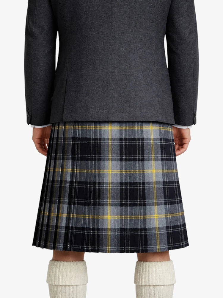 Person wearing a dark gray jacket and plaid kilt on a white background