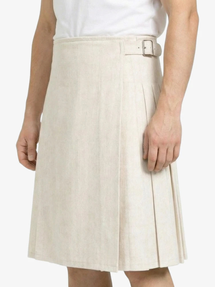 Beige pleated skirt worn by a person on a white background