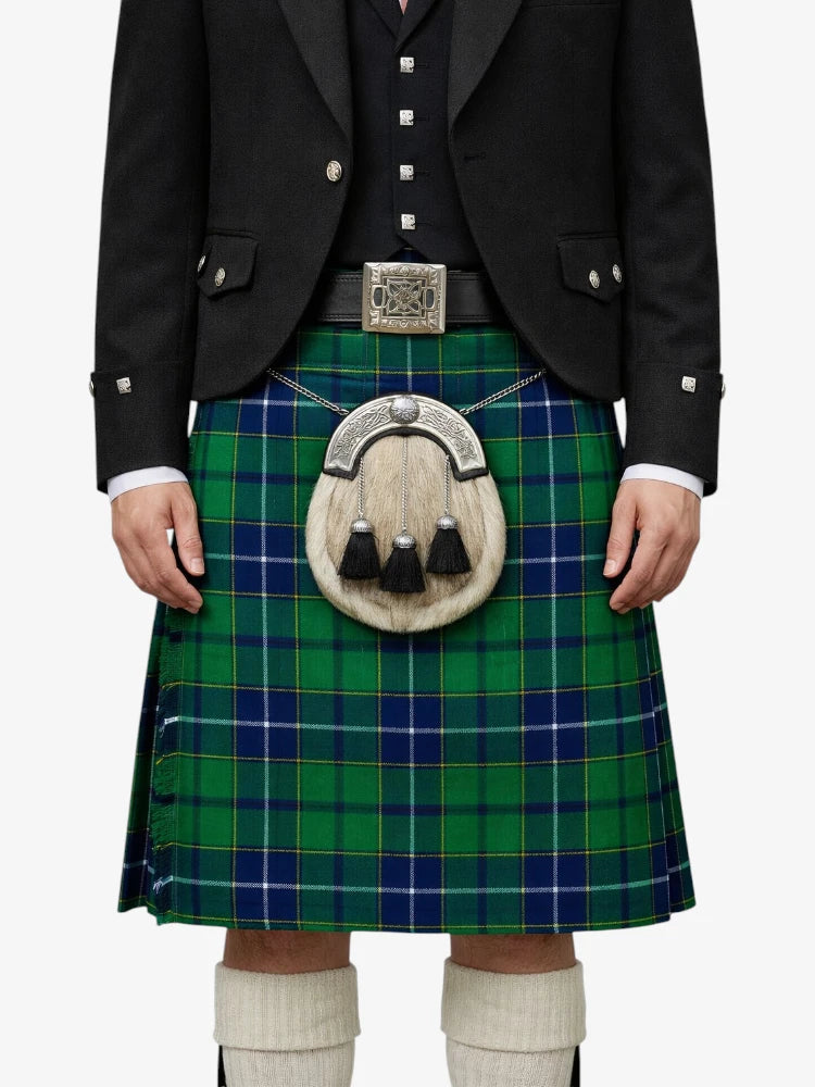 Person wearing a green and blue plaid kilt with a black jacket on a white background