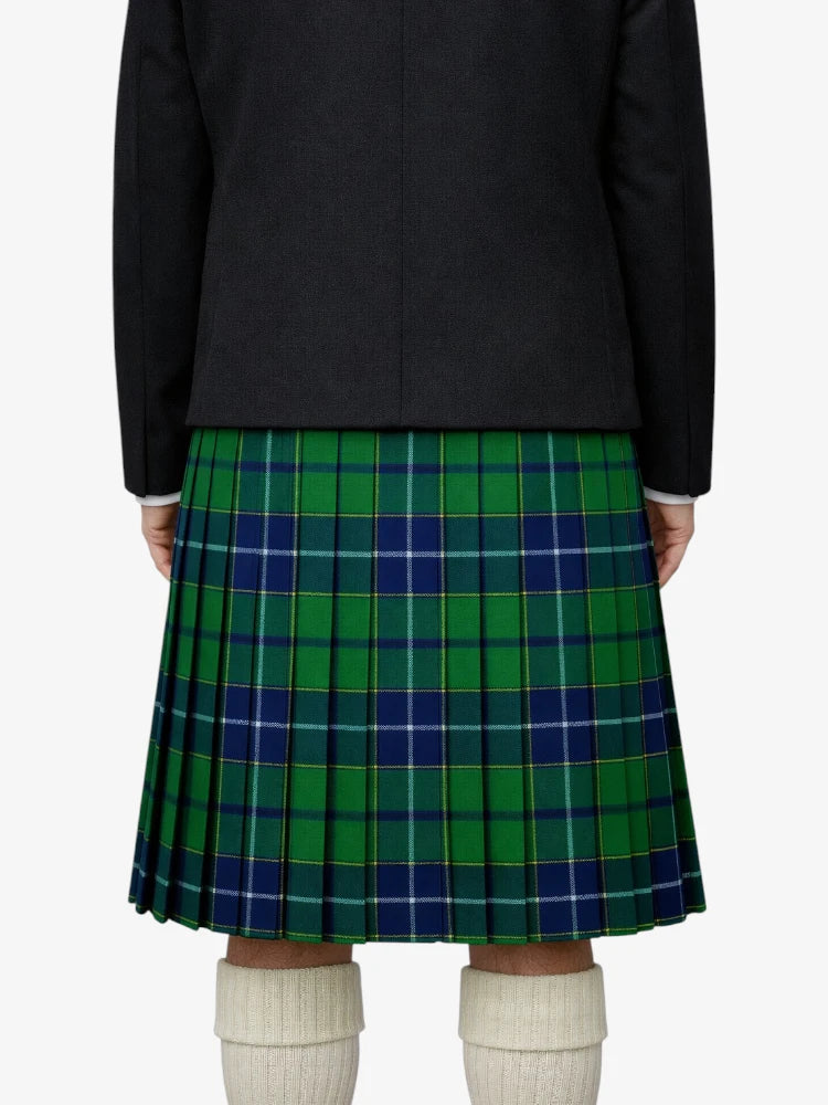Person wearing a green and blue plaid kilt with a black jacket on a white background